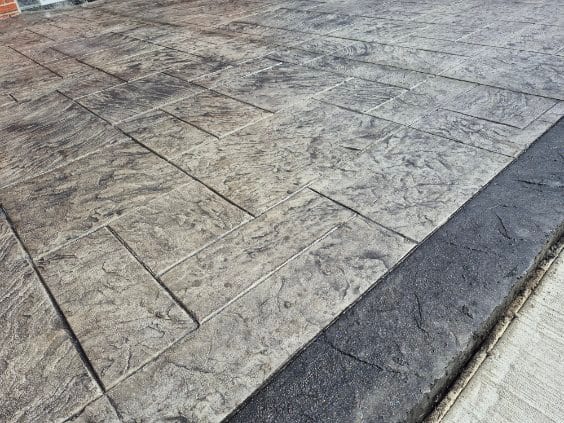 Ashlar stamped patio with a crisp cut edge by General Maintenance Works