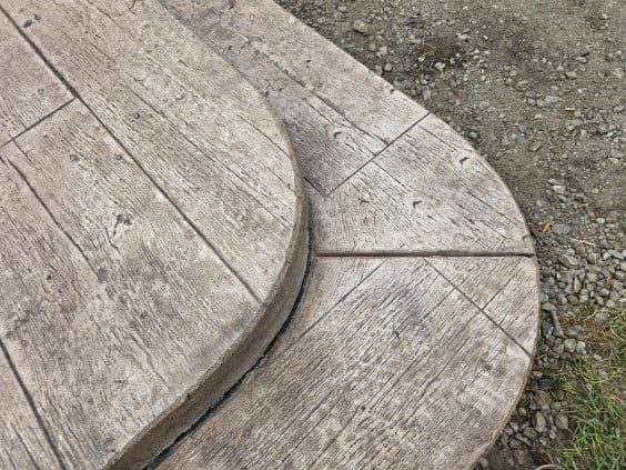 Wood-plank stamped concrete with a rounded edge by General Maintenance Works