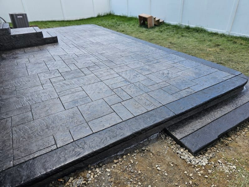 Charcoal ashlar-slate stamped patio by General Maintenance Works
